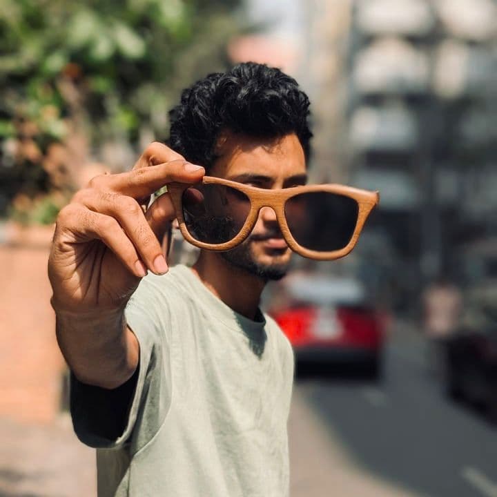 Handcrafted wooden sunglasses in use
